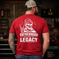 Red Fatherhood Building My Legacy T-shirt with large white skull back print, shown on a hardworking dad in a garage lifestyle setting. Great red dad shirt, Father’s Day gift, blue collar dad apparel, tattoo dad tee, biker dad clothing, skull graphic shirt, and proud fatherhood outfit.