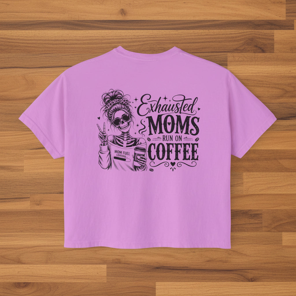 Purple women’s boxy cropped tee with black Exhausted Moms Run On Coffee graphic on the back.