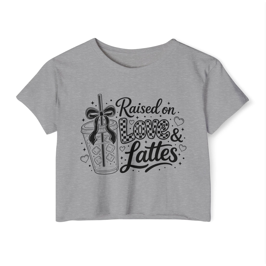 Heather gray women’s crop top displayed against a clean white background with the “Raised on Love & Lattes” coffee illustration centered on the front. The neutral fabric color and dark statement print create an easy-to-style caffeine shirt for jeans, leggings or shorts. Fun teacher gift, mom birthday present, stocking stuffer or everyday graphic tee for cappuccino and mocha fans.