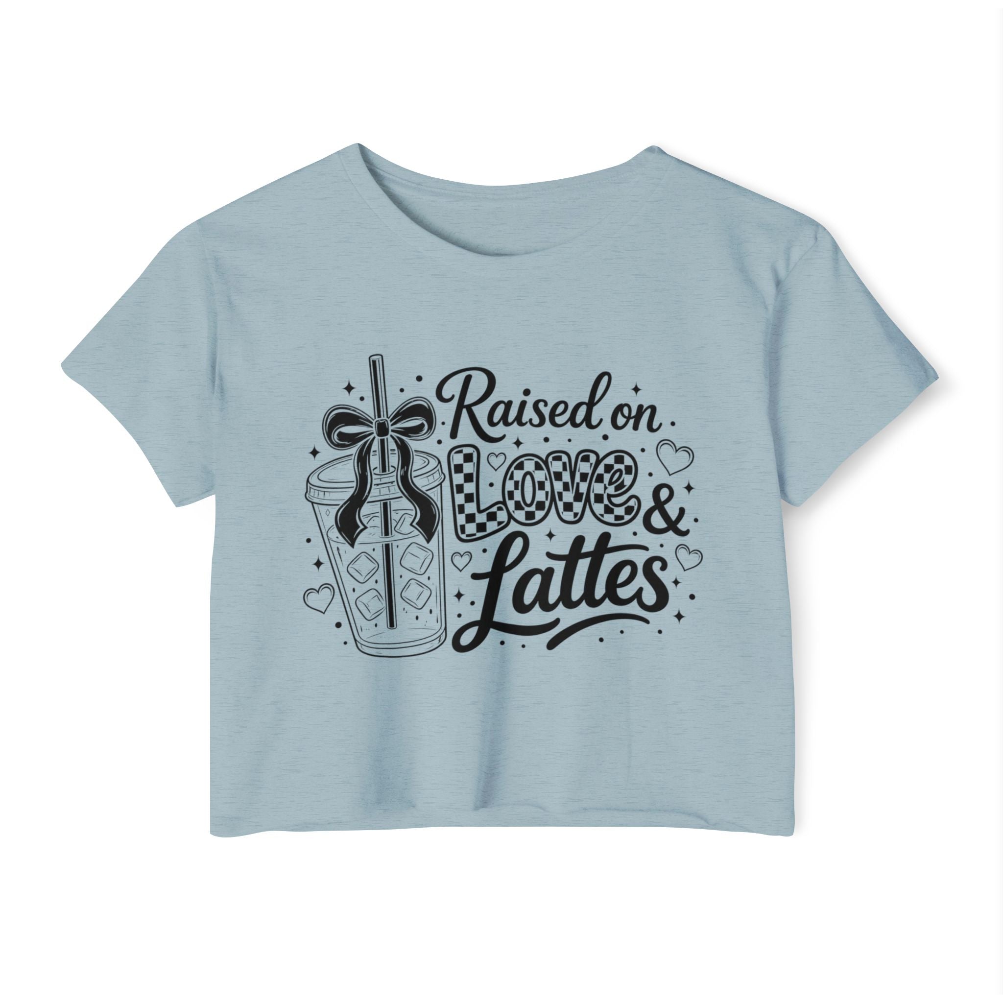 Powder blue cropped women’s T-shirt shown in a clear front-facing product photo with a bold black “Raised on Love & Lattes” design featuring a bow, checkerboard accents and café beverage. This pastel coffee lover shirt is ideal for spring outfits, relaxed weekends and morning drink runs. Unique gift choice for baristas, cold brew enthusiasts, college students and latte-loving friends.