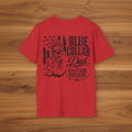 Red Blue Collar Dad t-shirt with Never Done Building graphic shown on a woodgrain background.