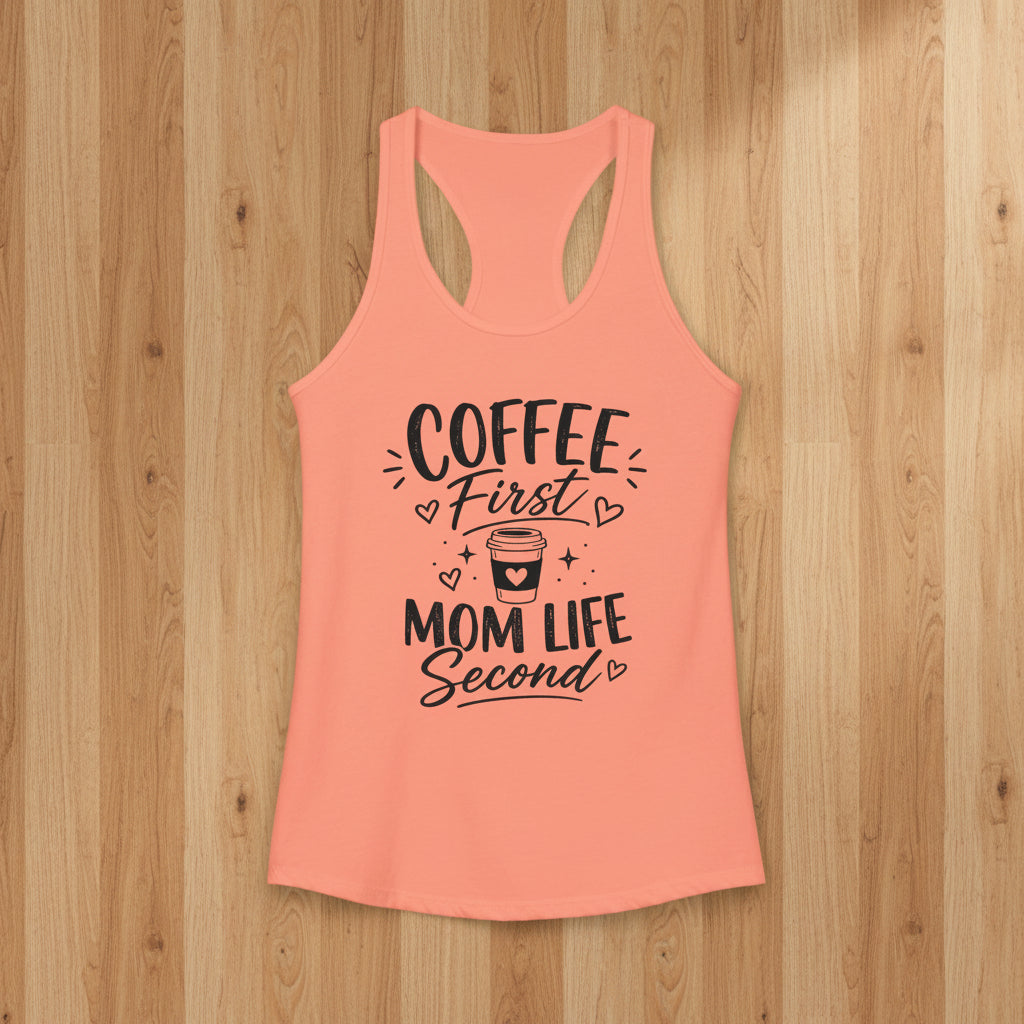 Peach Coffee Mom racerback tank top with black Coffee First Mom Life Second text on a woodgrain background.