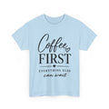 A light blue short-sleeve crewneck t-shirt with a black graphic print on the front reading 'Coffee FIRST EVERYTHING ELSE can wait' with small heart accents, shown on a plain white background.