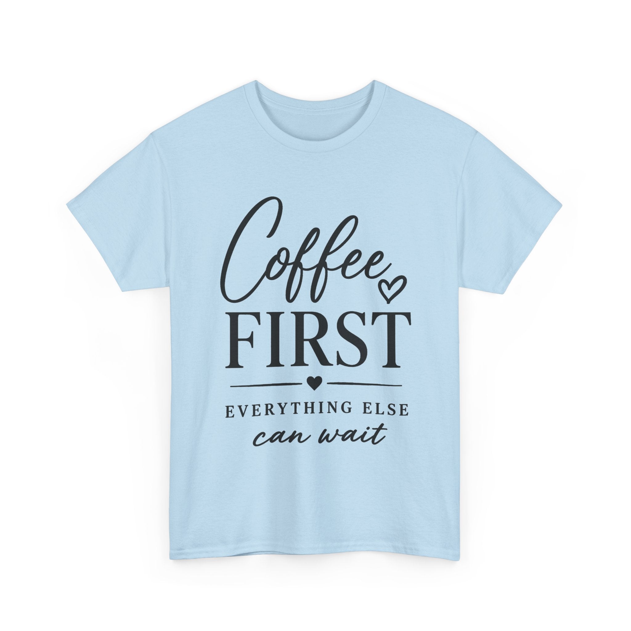 A light blue short-sleeve crewneck t-shirt with a black graphic print on the front reading 'Coffee FIRST EVERYTHING ELSE can wait' with small heart accents, shown on a plain white background.