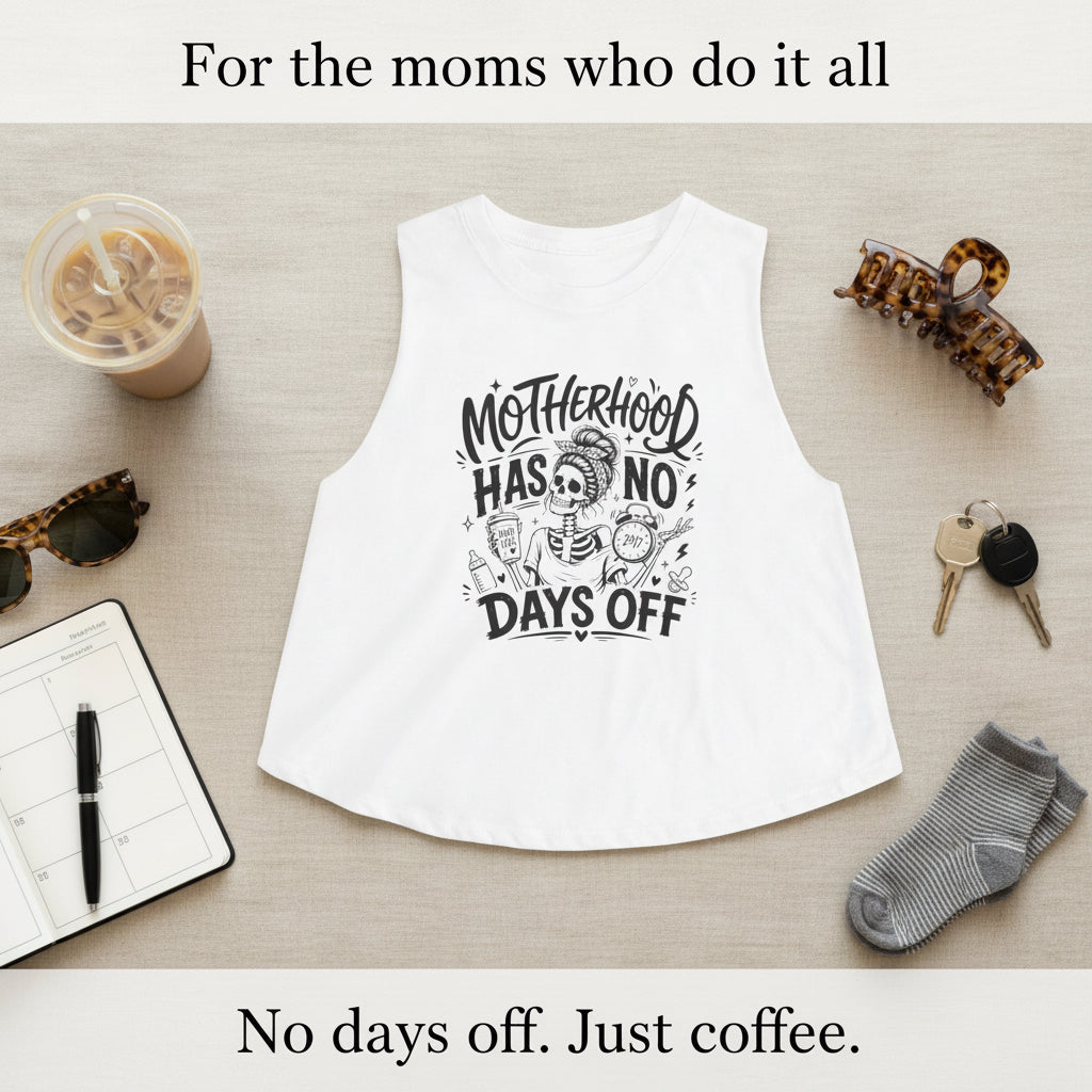 White Motherhood Has No Days Off crop tank with black mom life graphic on a beige background.