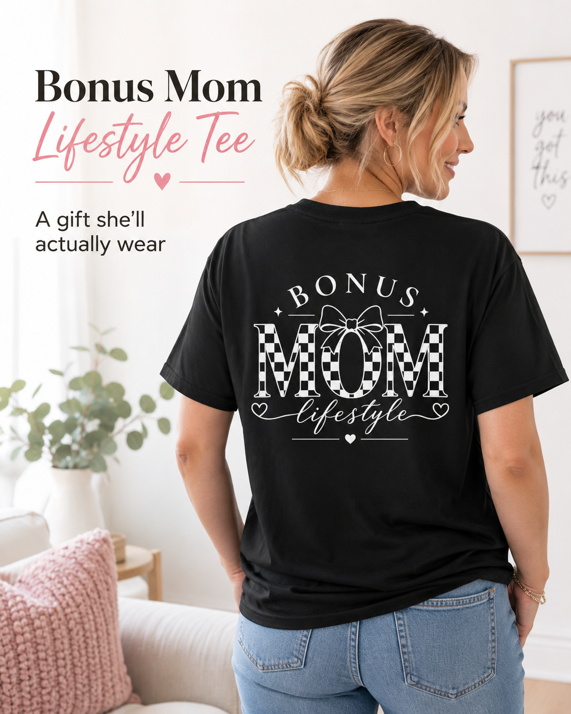 Woman wearing a black t-shirt with 'Bonus Mom Lifestyle' text in a home setting
