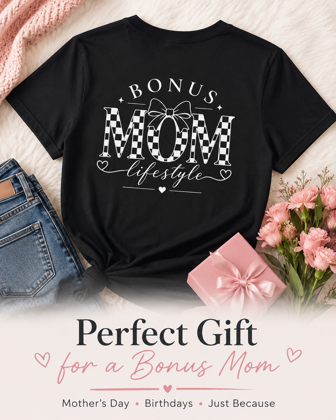 Black t-shirt with 'Bonus Mom' text, placed on a surface with jeans, a gift, and flowers.