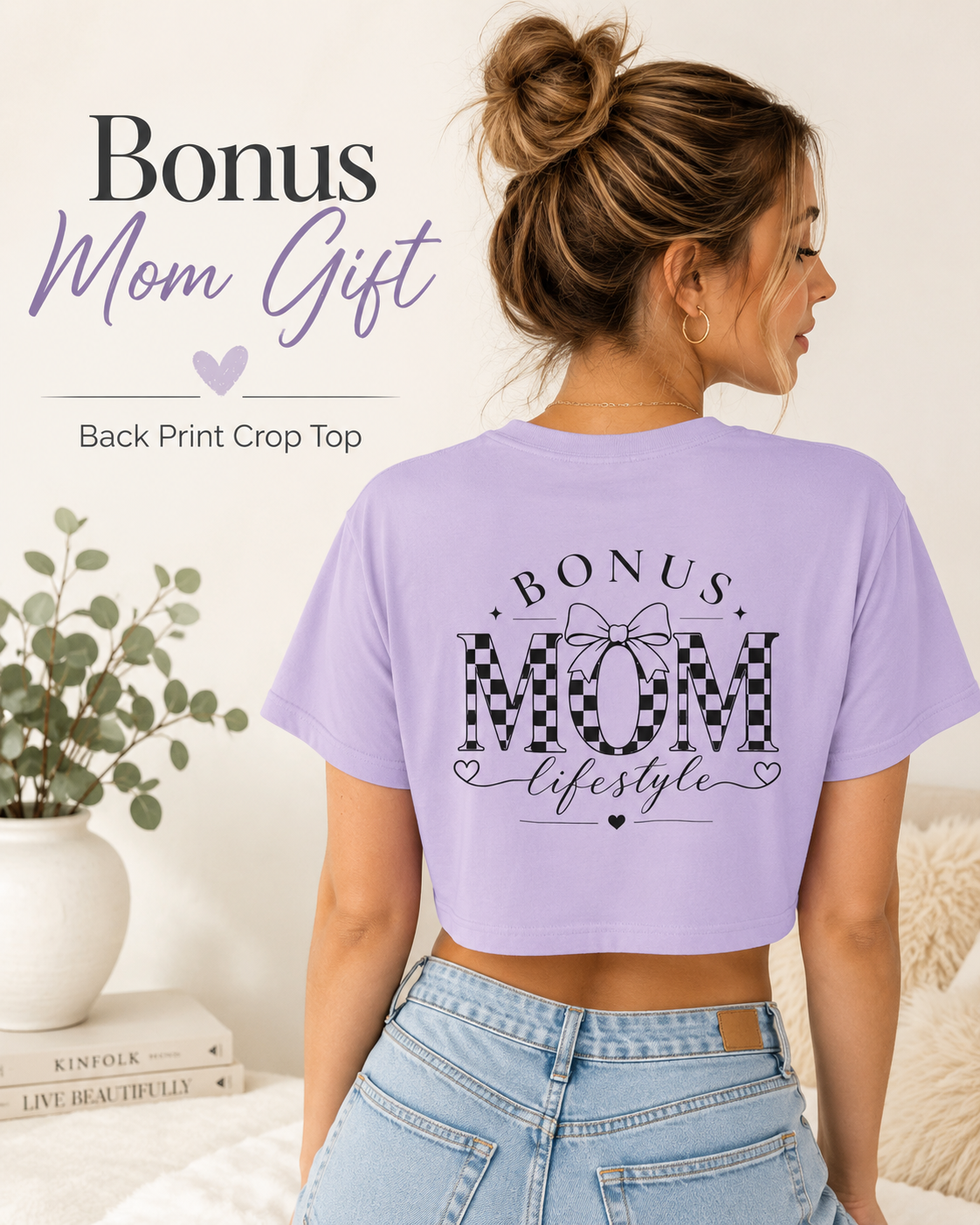 Woman wearing a purple crop top with 'Bonus Mom' text, standing in a home setting.