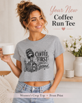 Woman wearing a gray crop top with a skeleton design and text, holding a coffee cup.