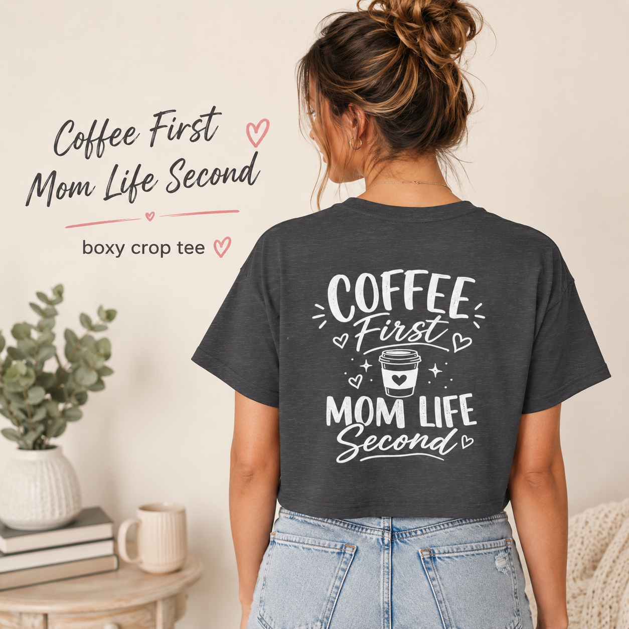 Charcoal Coffee First Mom Life Second crop top shown from the back on a woman in jeans, featuring a bold white coffee mom graphic and soft casual styling. Funny caffeine mama shirt for busy moms, coffee lovers, school drop off outfits, everyday mom life wear, birthday gifts, Mother’s Day gifts, and cute relaxed summer style.