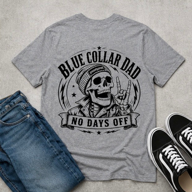 Heather gray dad graphic tee arranged with blue jeans and black canvas shoes, showing a rugged skeleton wearing a backward cap beneath the message “BLUE COLLAR DAD” and “NO DAYS OFF.” Great work shirt for proud fathers, blue collar workers, contractors, mechanics, builders, laborers, husband gifts, Father’s Day surprises, birthday celebrations, and relaxed weekend outfits.