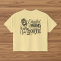 Butter yellow women’s boxy cropped tee with black Exhausted Moms Run On Coffee graphic design.