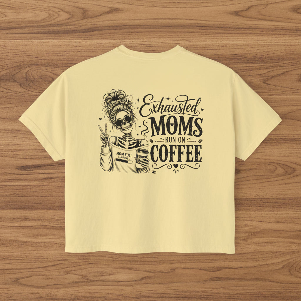 Butter yellow women’s boxy cropped tee with black Exhausted Moms Run On Coffee graphic design.