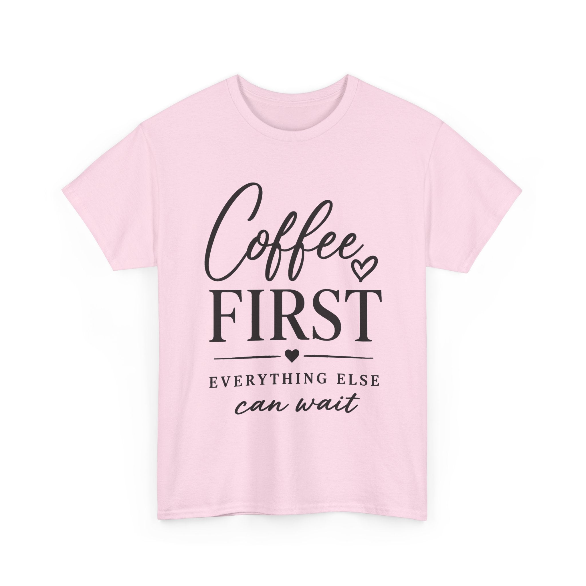 A light pink short-sleeve crewneck t-shirt with a black graphic text print reading 'Coffee FIRST EVERYTHING ELSE can wait' on the front, displayed against a plain white background.