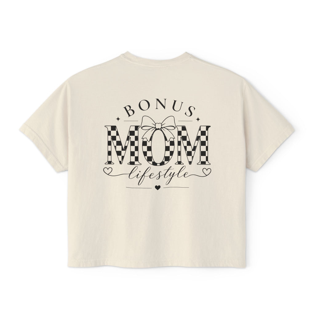 Beige t-shirt with 'Bonus Mom Lifestyle' text and checkered design on a white background