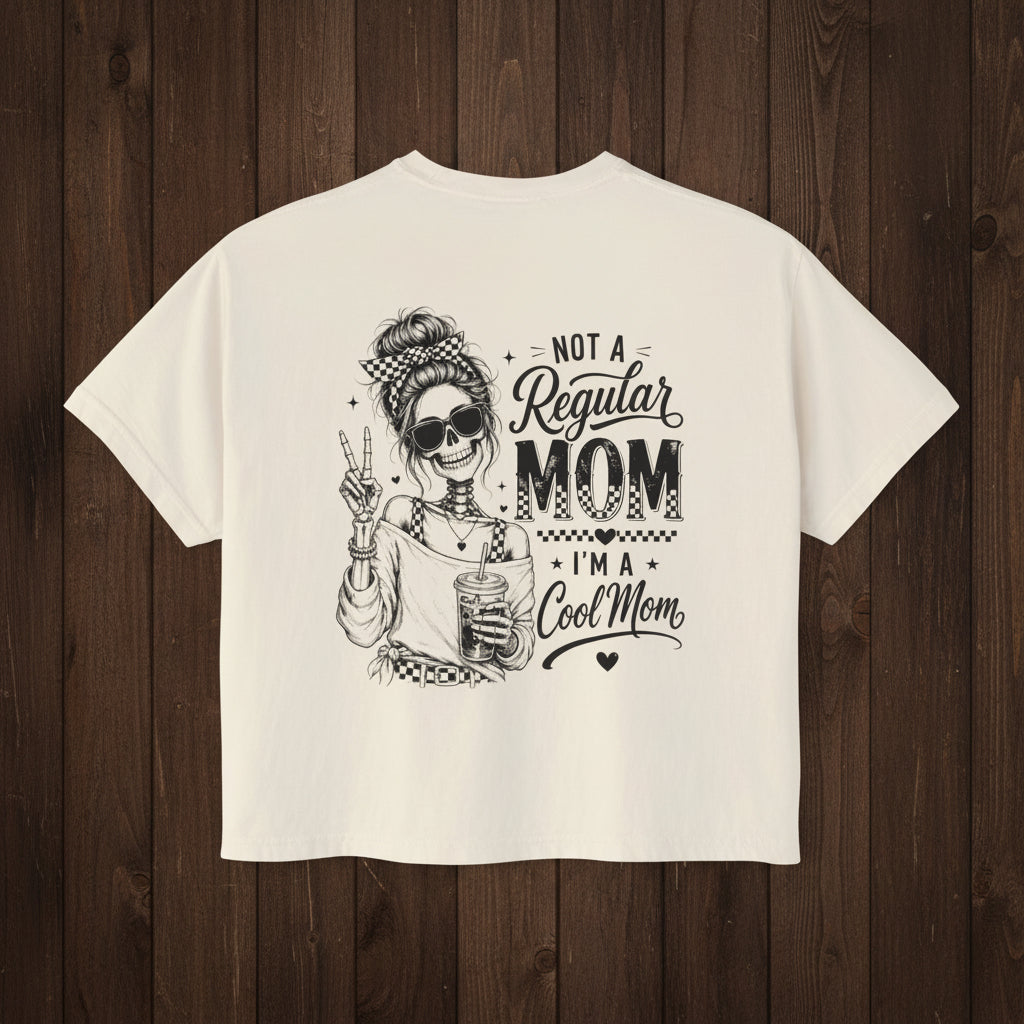 Women’s ivory boxy cropped tee with black Cool Mom skeleton coffee graphic on the back.