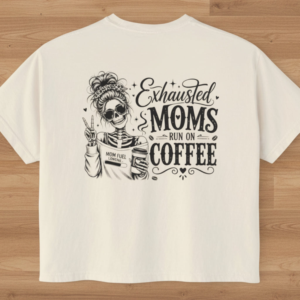 Women’s boxy cropped tee with black Exhausted Moms Run On Coffee graphic design on the back.
