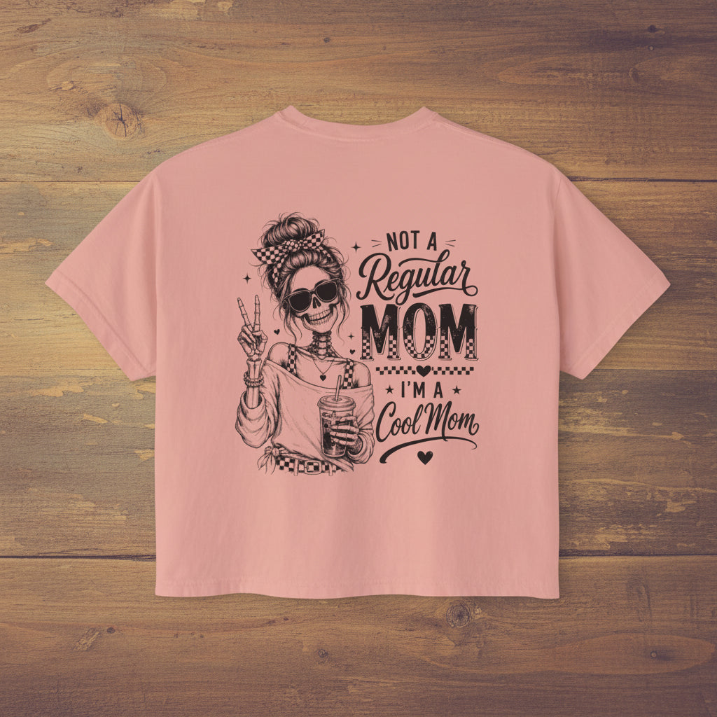 Women’s pink boxy cropped tee with black Cool Mom skeleton coffee graphic on the back.