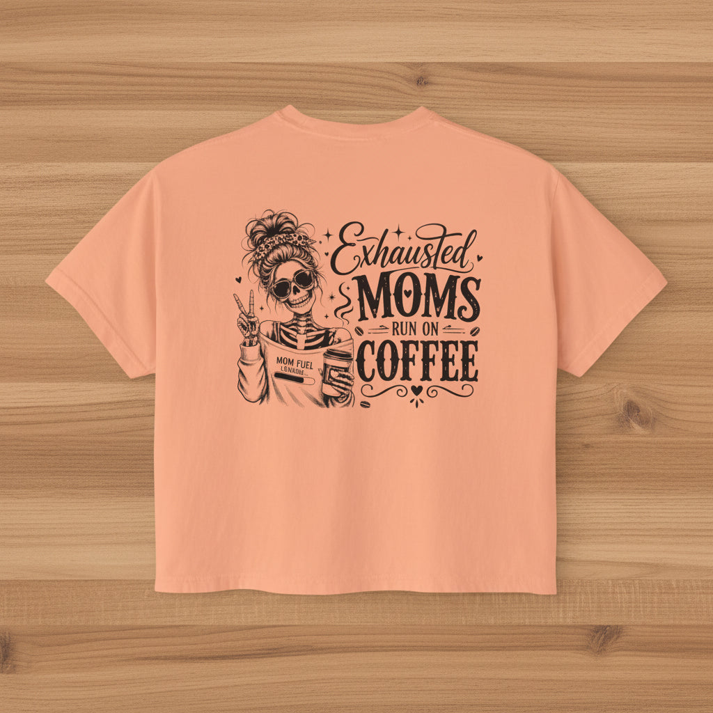 Peach women’s boxy cropped tee with black Exhausted Moms Run On Coffee graphic design.
