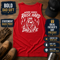Red sleeveless fatherhood tank top flat lay with a large white “Work Hard Raise Hard Dad Life” graphic print across the back. Overlays say “Bold Dad Gift,” “Statement Back Print,” “Ideal Father’s Day Present,” “Comfort for Warm Days,” “Dad Life Tank Top,” and “Built for Everyday Wear.” A sharp summer shirt for dads, blue collar men, gym days, cookouts, vacations, and everyday casual menswear.