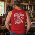 Garage lifestyle photo of a man wearing a red back print tank top, styled for hardworking dads, mechanics, blue collar husbands, father figures, weekend warriors, shop clothing, warm weather work outfits, and bold dad life apparel.