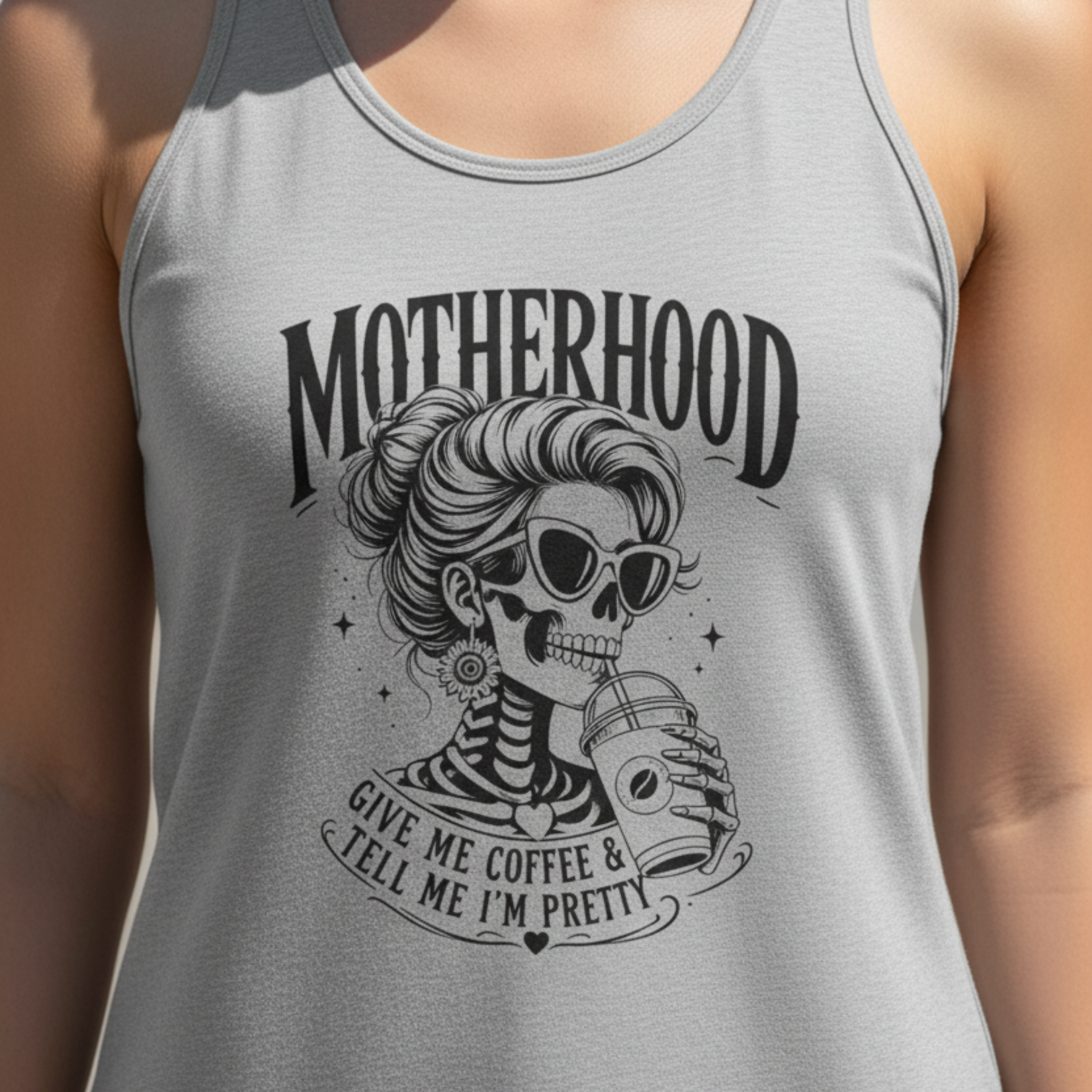 Heather gray women’s racerback tank top featuring a bold black Motherhood graphic with a stylish skeleton mom wearing sunglasses and holding an iced coffee. The design reads “Give Me Coffee & Tell Me I’m Pretty,” creating a funny mom-life shirt for coffee-loving mothers, busy moms, birthdays, Mother’s Day gifts, casual summer outfits and everyday wear.