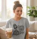 Woman wearing a heather gray Coffee First Mom Life Second cropped t-shirt while enjoying an iced coffee indoors. Women's graphic coffee shirt with skeleton design, cozy lounge outfit, trendy mom fashion, casual crop tee, coffee enthusiast apparel, birthday gift for moms, relaxed everyday clothing.