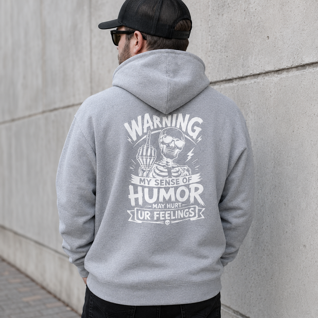 Light gray funny sarcasm hoodie with white skeleton warning back print, My Sense of Humor May Hurt Ur Feelings sweatshirt, men’s graphic pullover, edgy joke hoodie, casual streetwear, humor quote apparel, funny gift for him, everyday fall winter hoodie with bold back design.