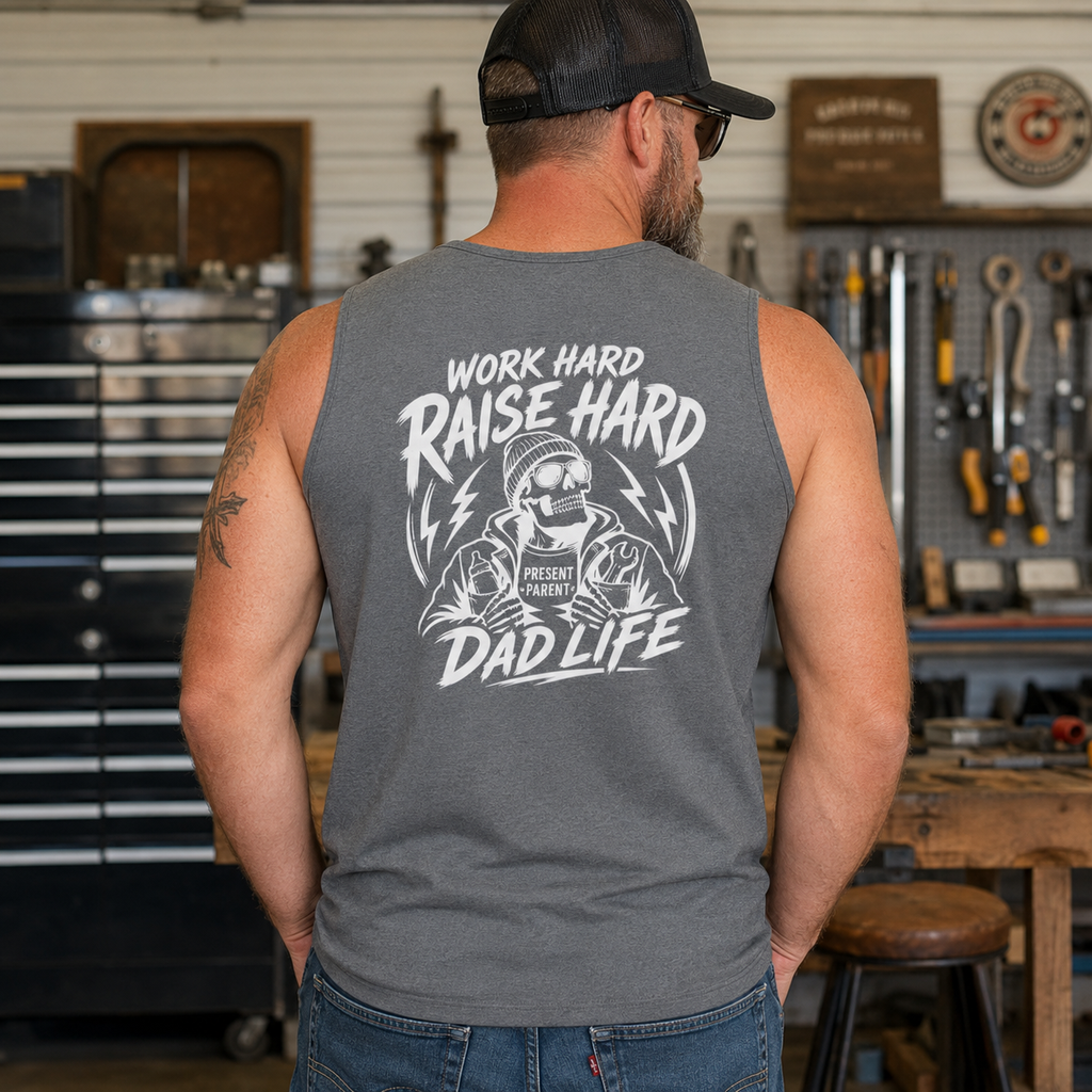 Lifestyle image of a man in a gray sleeveless dad shirt inside a workshop, featuring a large back design for tradesmen, tool lovers, blue collar fathers, stepdad gifts, weekend project outfits, tattooed dads, and casual shop clothing.